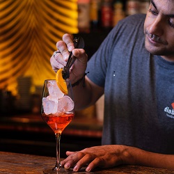 bartenders mix alcoholic beverages around a bar